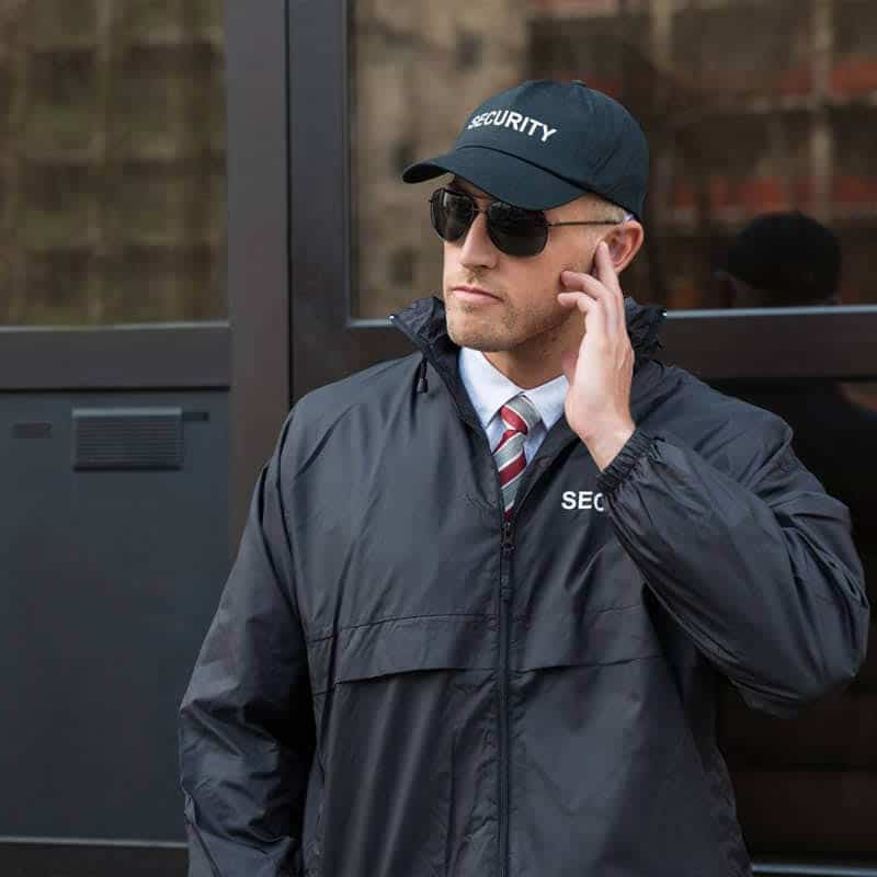 Door security wearing a cap and dark glasses